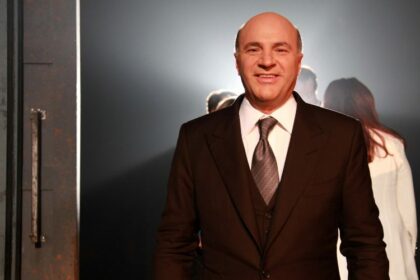 Beanstox Chairman and co-owner Kevin O'Leary smiling backstage at an event.